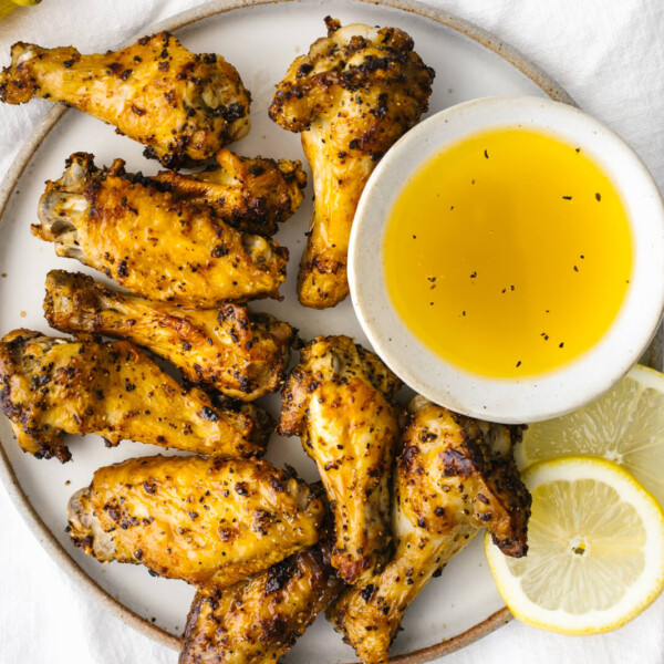 A plate of lemon pepper air fryer chicken wings on a napkin