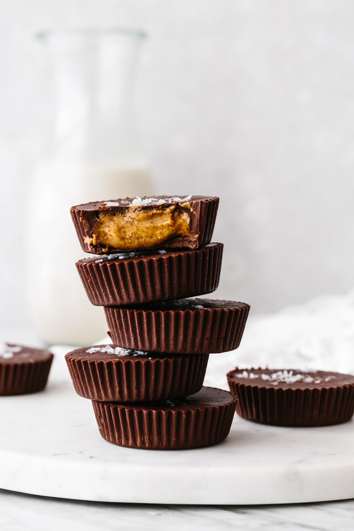 Almond butter cups layered on a table.