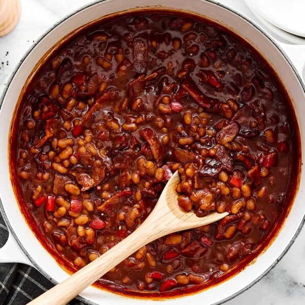 A white pot of baked baked beans.