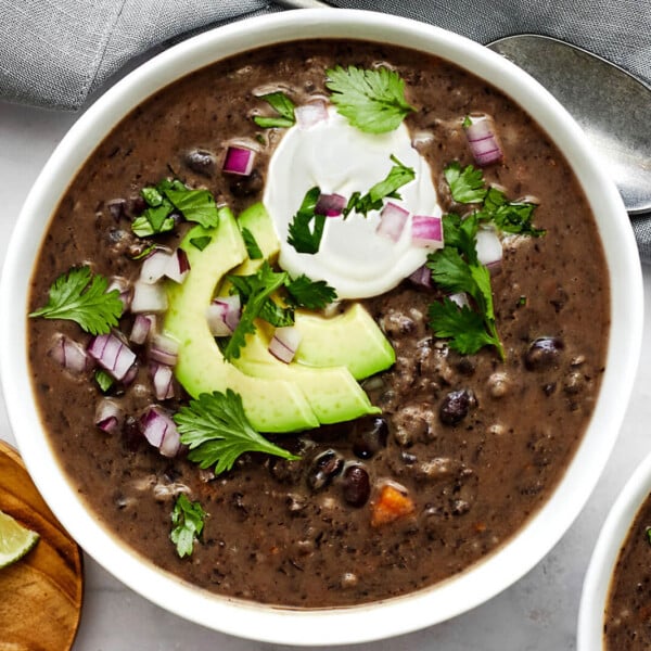 A white bowl of black bean soup