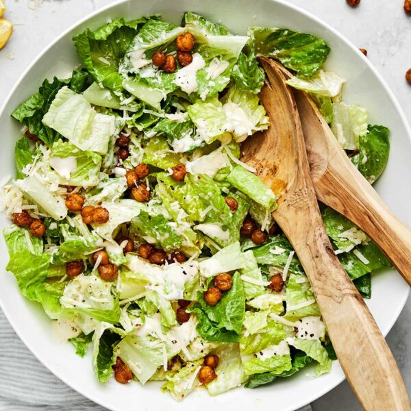 A white bowl of Caesar salad.