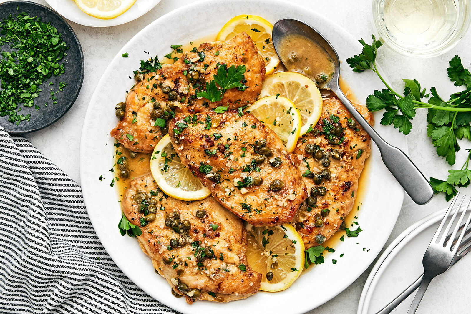 Chicken piccata filled on a white plate