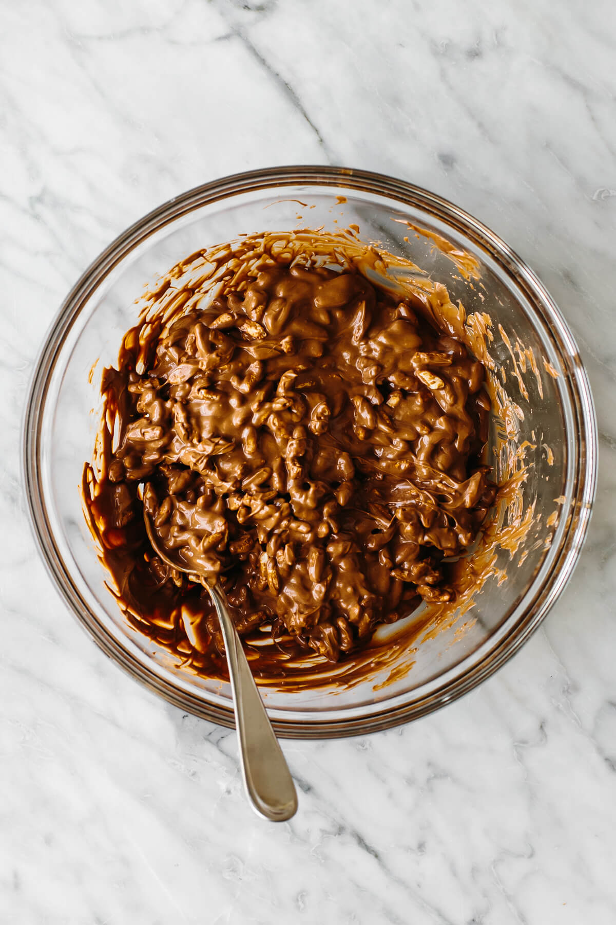 Mixing chocolate and puffed rice in a bowl.