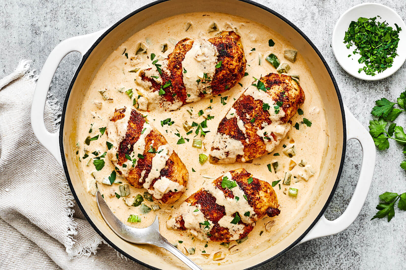 A white pan of creamy cajun chicken