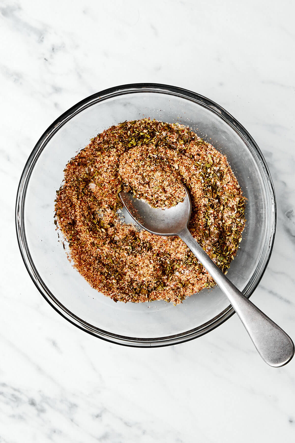 Mixing seasoning in a bowl.