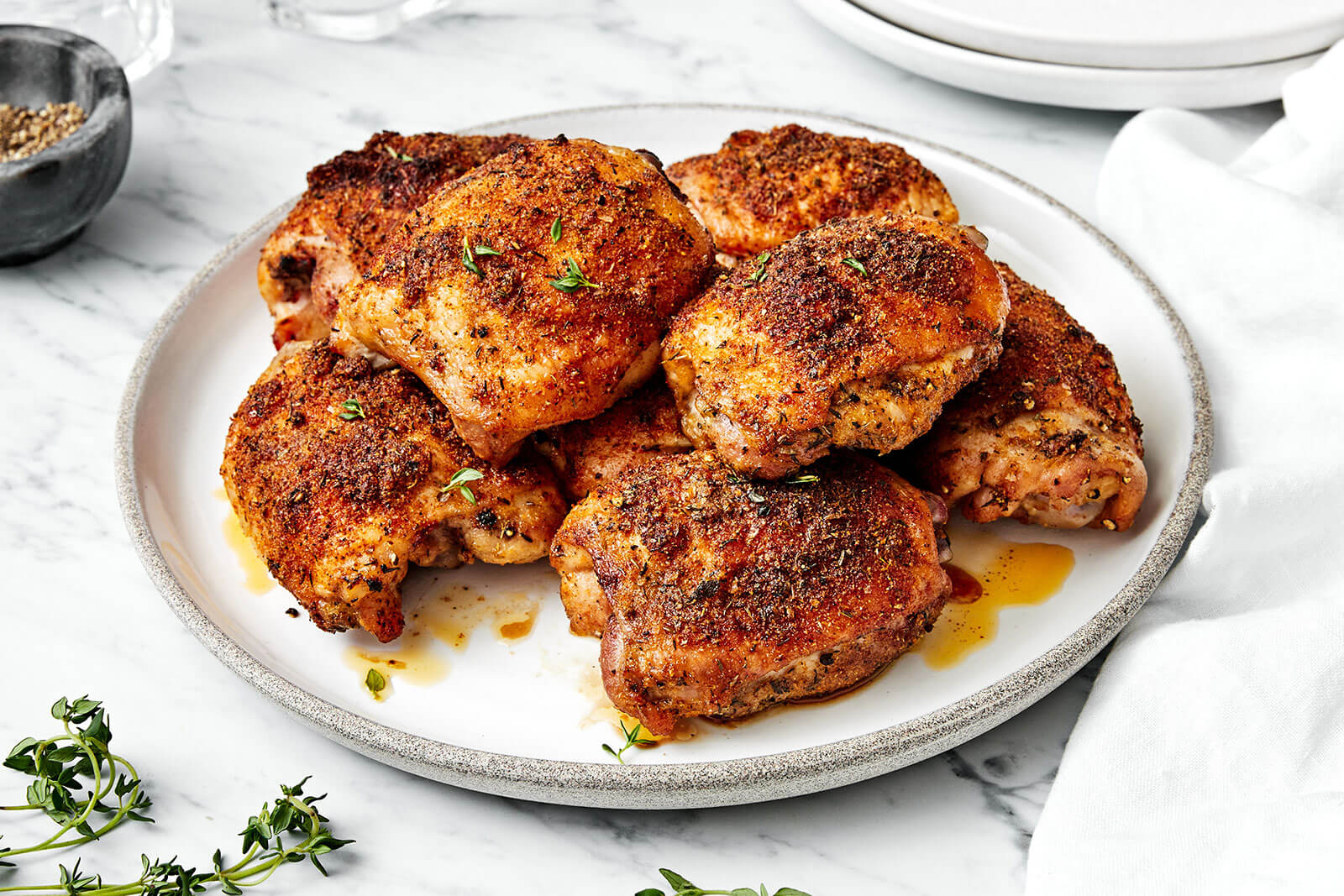 A plate of baked chicken thighs.