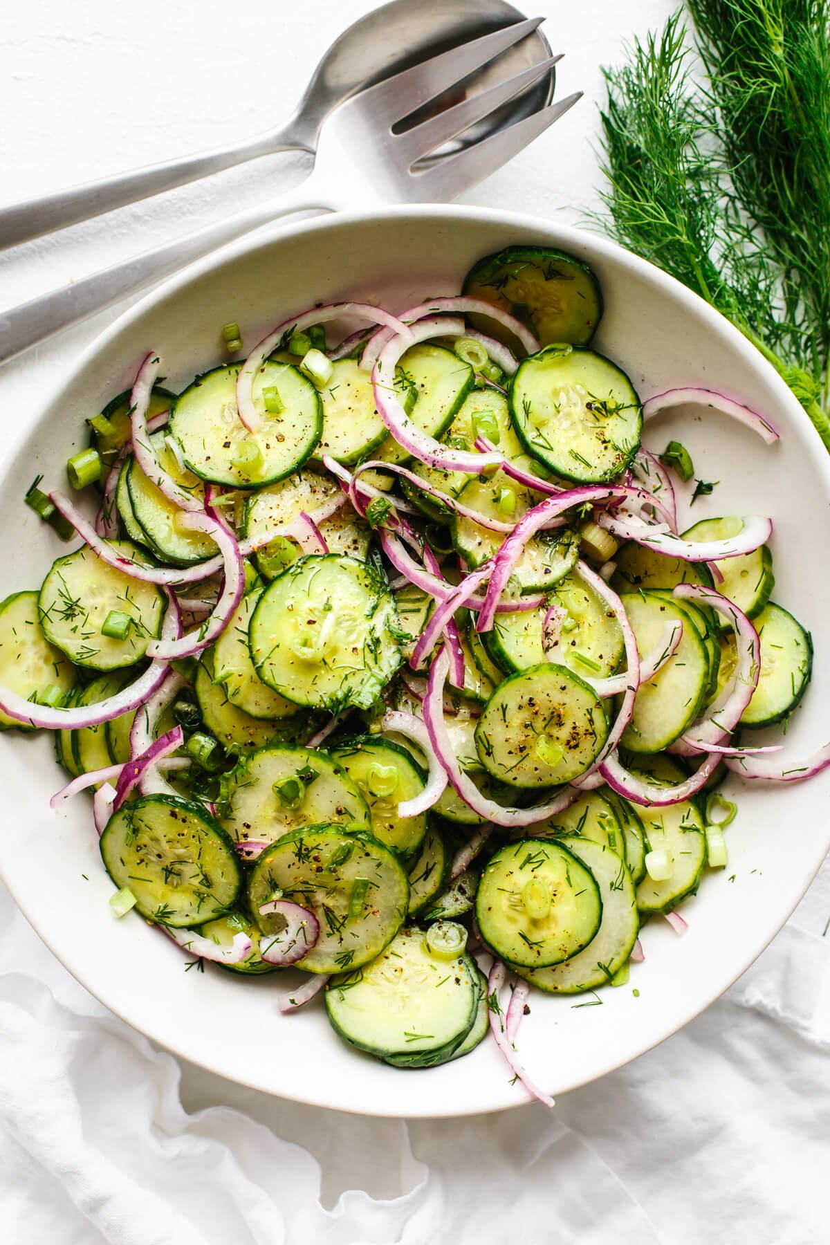 Cucumber salad in a large white bowl