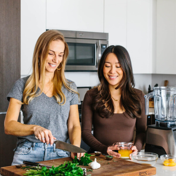 Lisa Bryan and Emily Liao in the kitchen testing recipes for Downshiftology