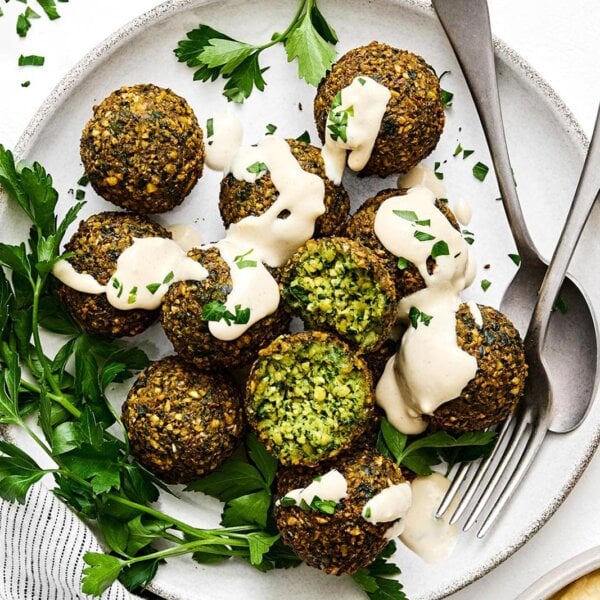 A plate of falafels and tahini sauce.