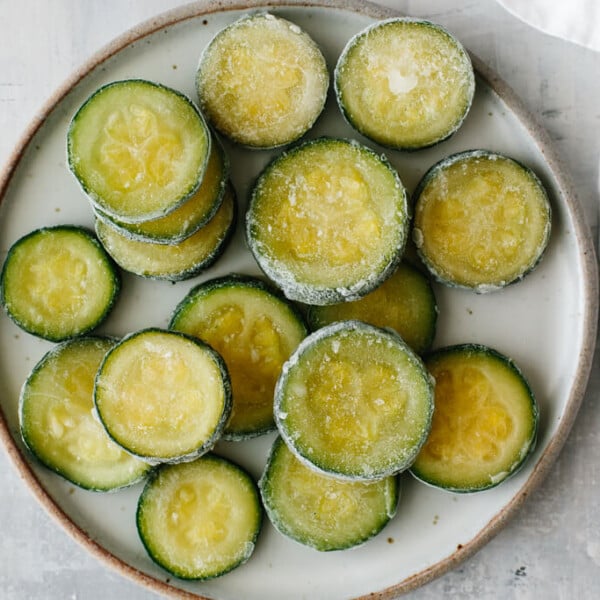 Frozen zucchini slices on a plate.