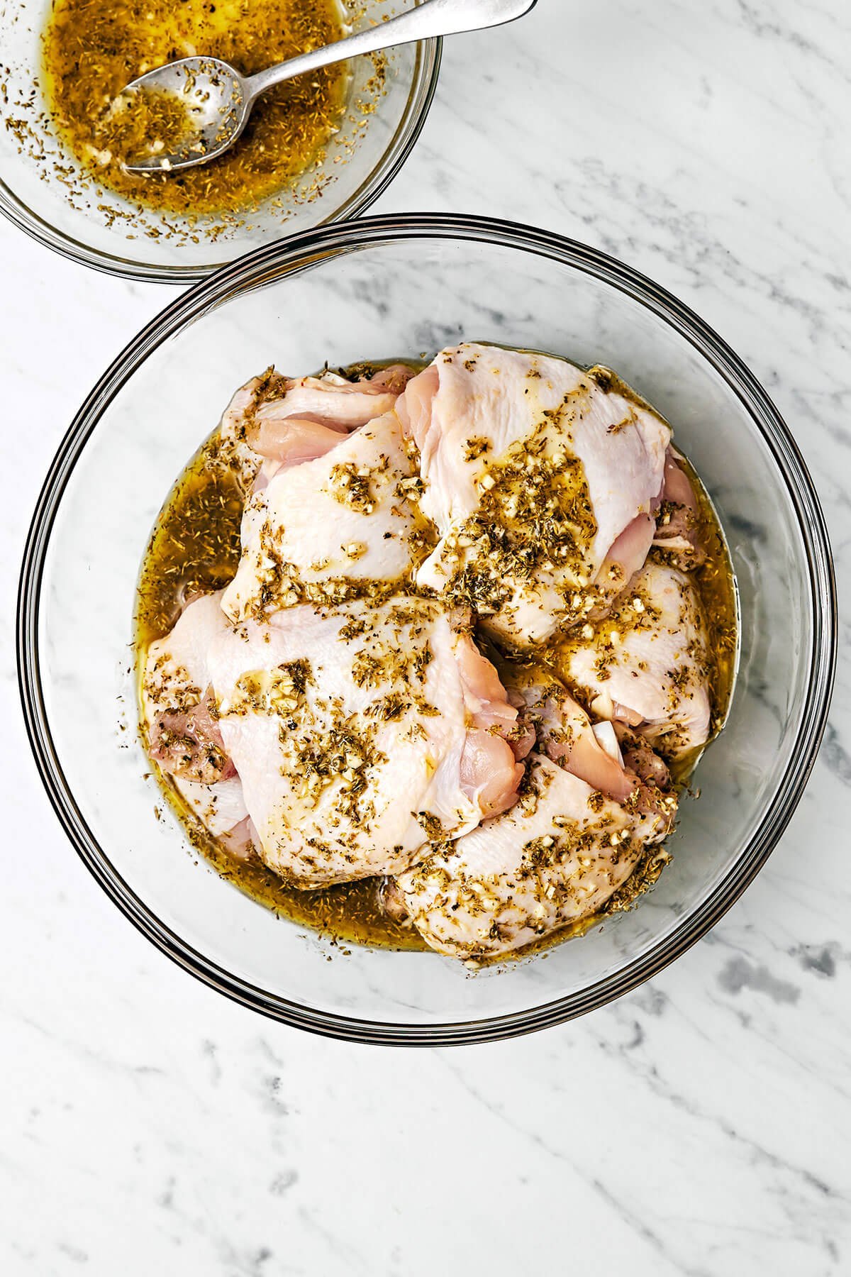 Marinating Greek lemon chicken in a bowl