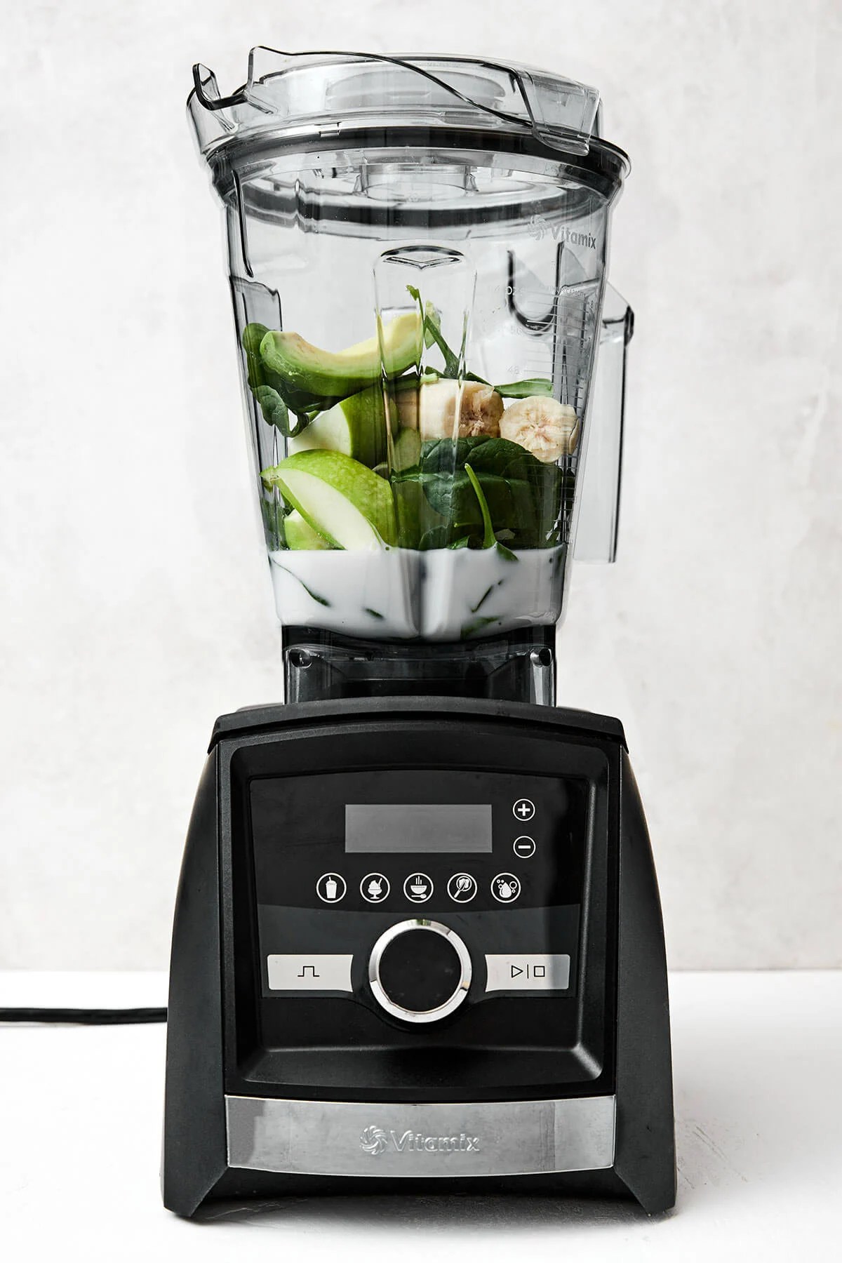 Green smoothie ingredients in a blender.