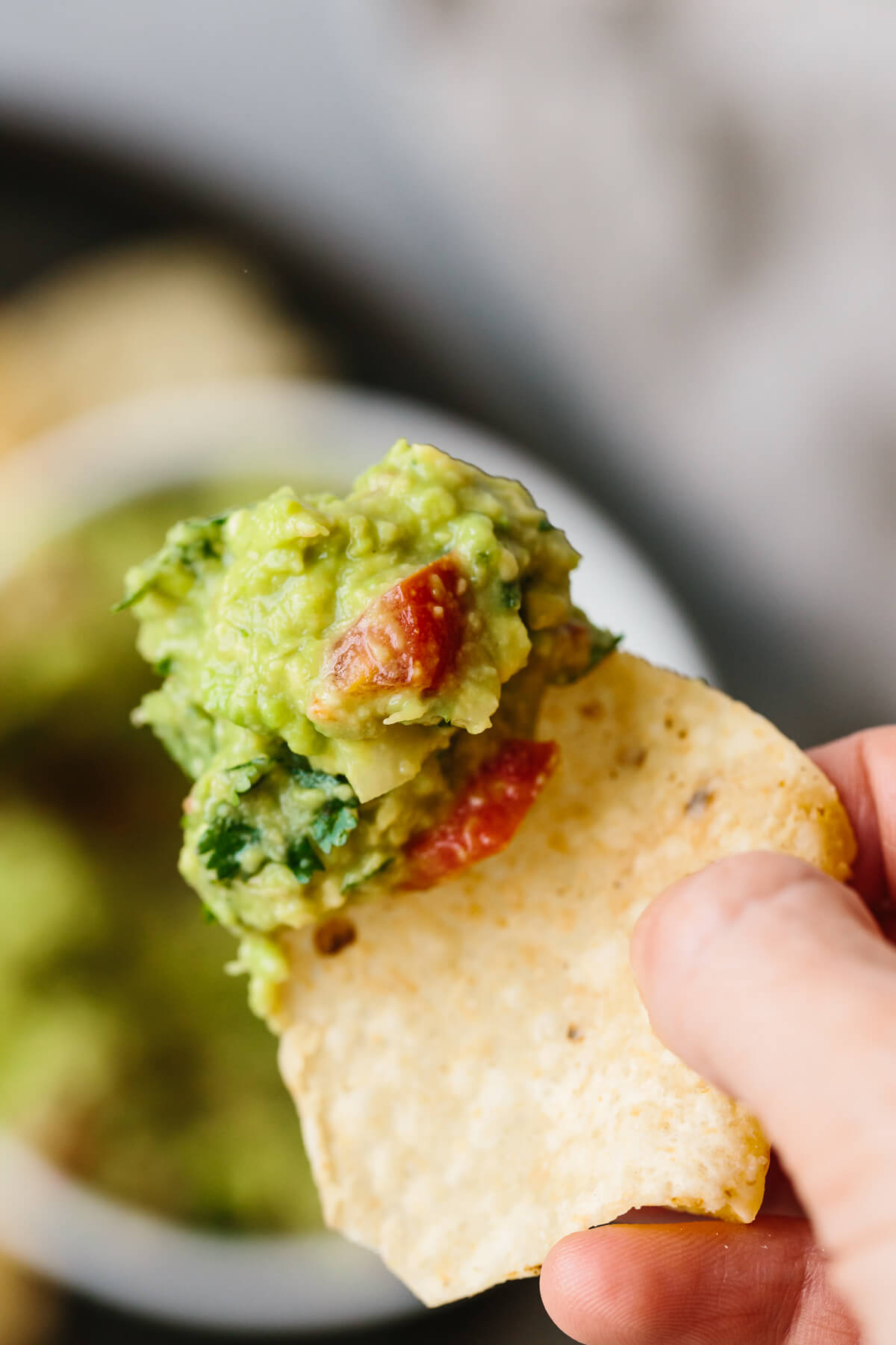 A scoop of guacamole on a tortilla chip.