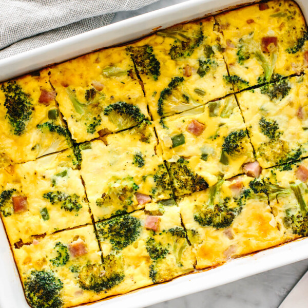 A white dish of ham and broccoli casserole