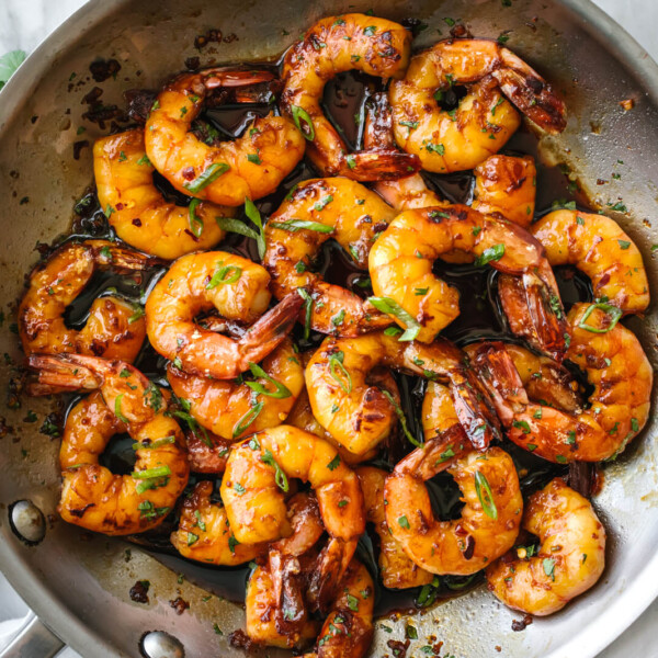 Honey garlic shrimp sauteed in a pan next to a napkin