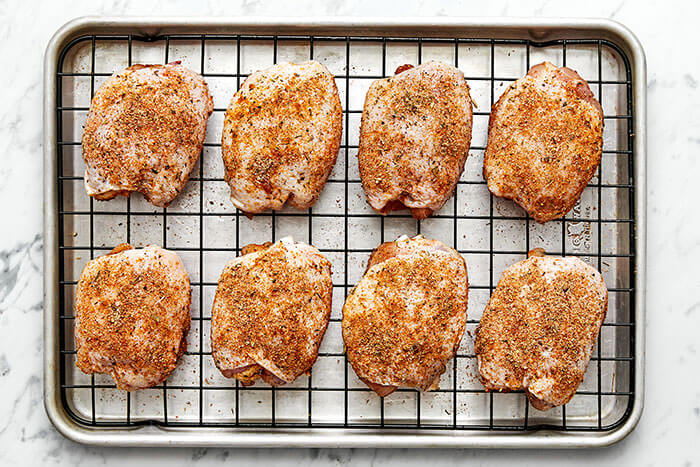 A sheet pan of chicken thighs.