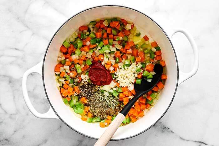 Cooked vegetables and spices in a pot.