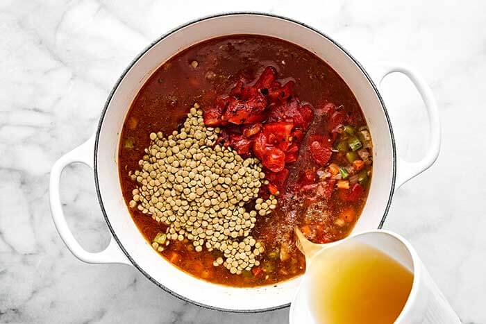 Broth and veggies simmering in a pot.