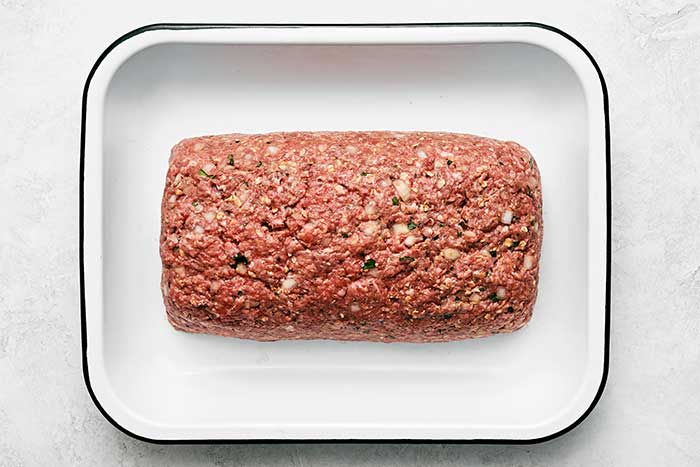 A pan of raw meatloaf.