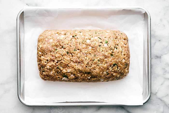 Ground turkey meatloaf on a baking pan.