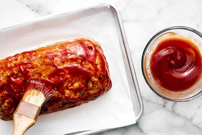 Glazed turkey meatloaf on a baking pan.