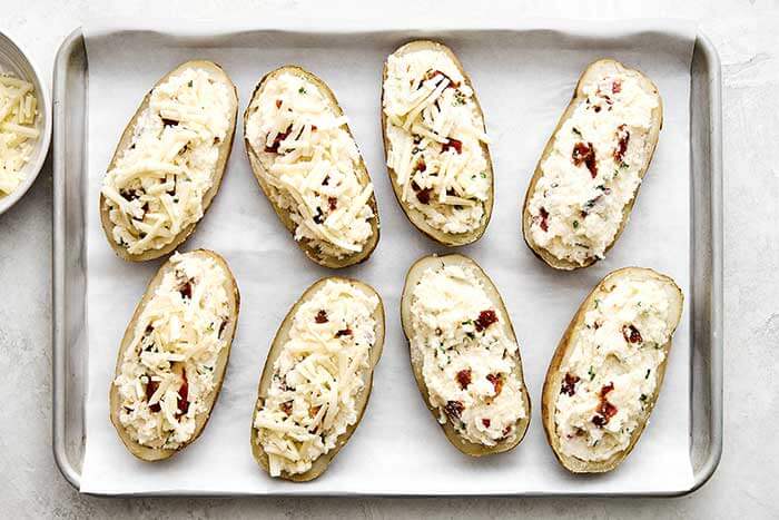 Twice baked potatoes on a sheet pan.