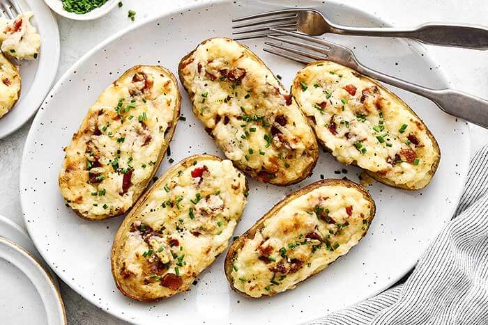 Twice baked potatoes with a fork.