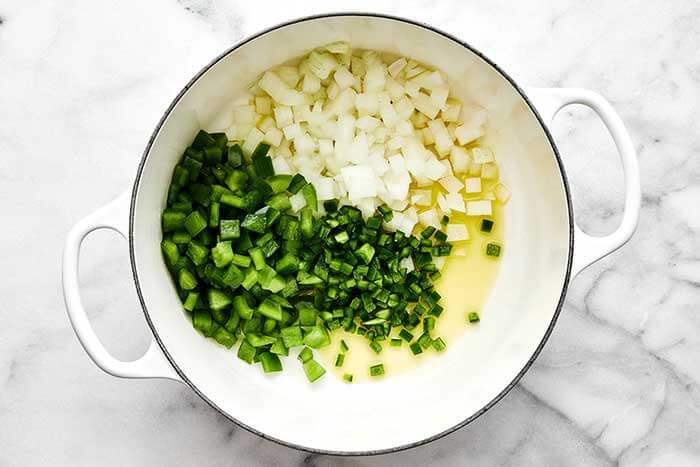 Cooked onion and bell pepper in a pot.