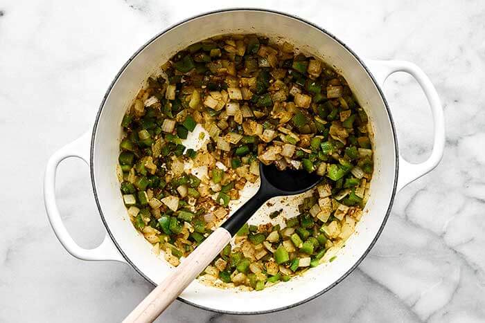 Cooked vegetables and spices in a pot.