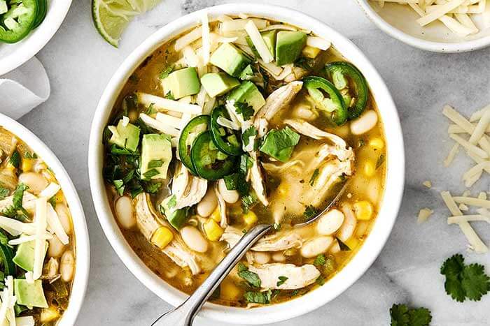 White chicken chili in a bowl with a spoon.