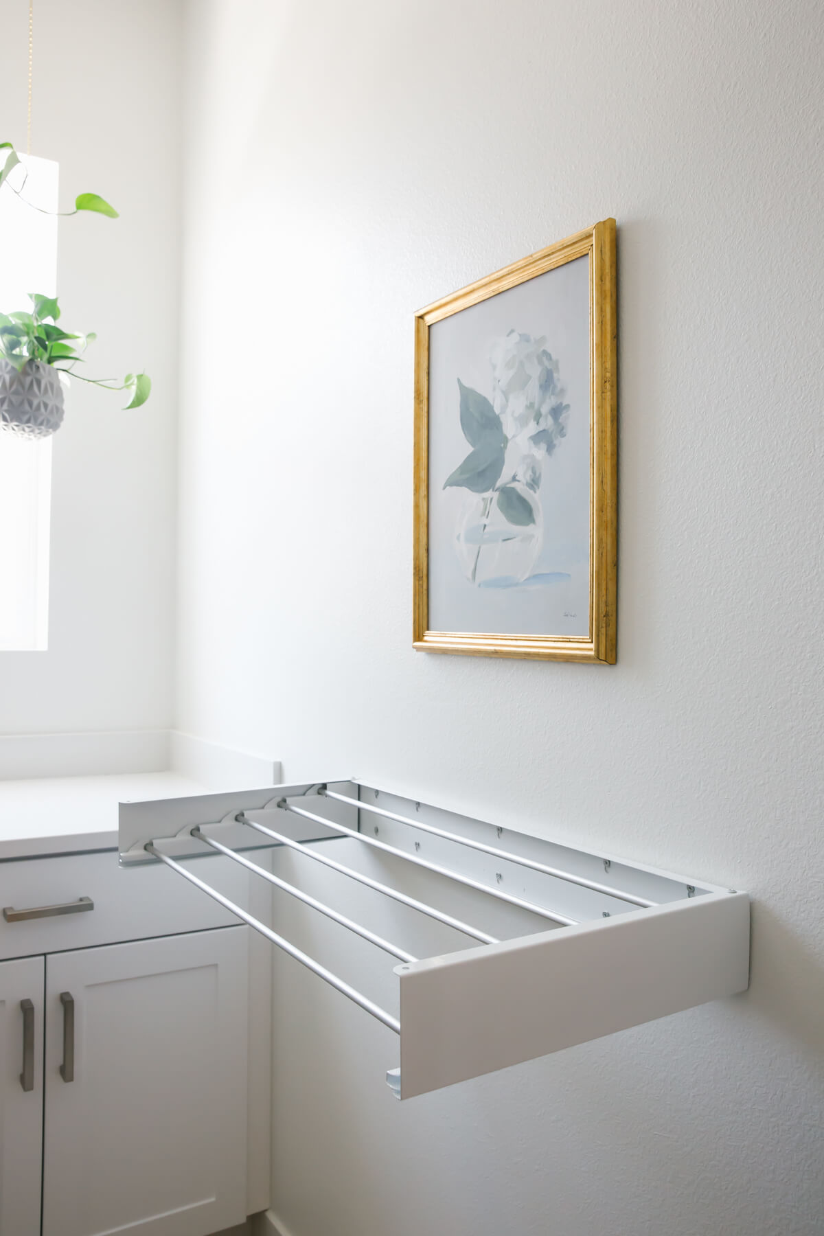 Wall drying rack in laundry room.