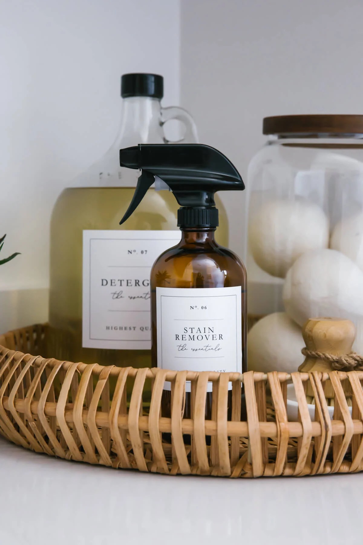 Cleaning supplies in laundry room in wicker basket.