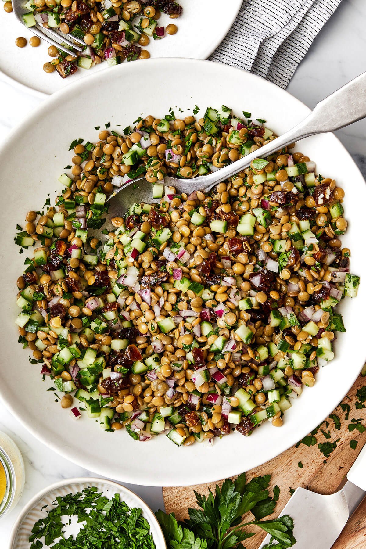 A white bowl of lentil salad.