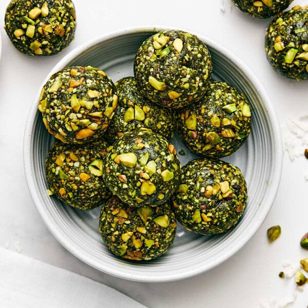 A white bowl of matcha energy balls.