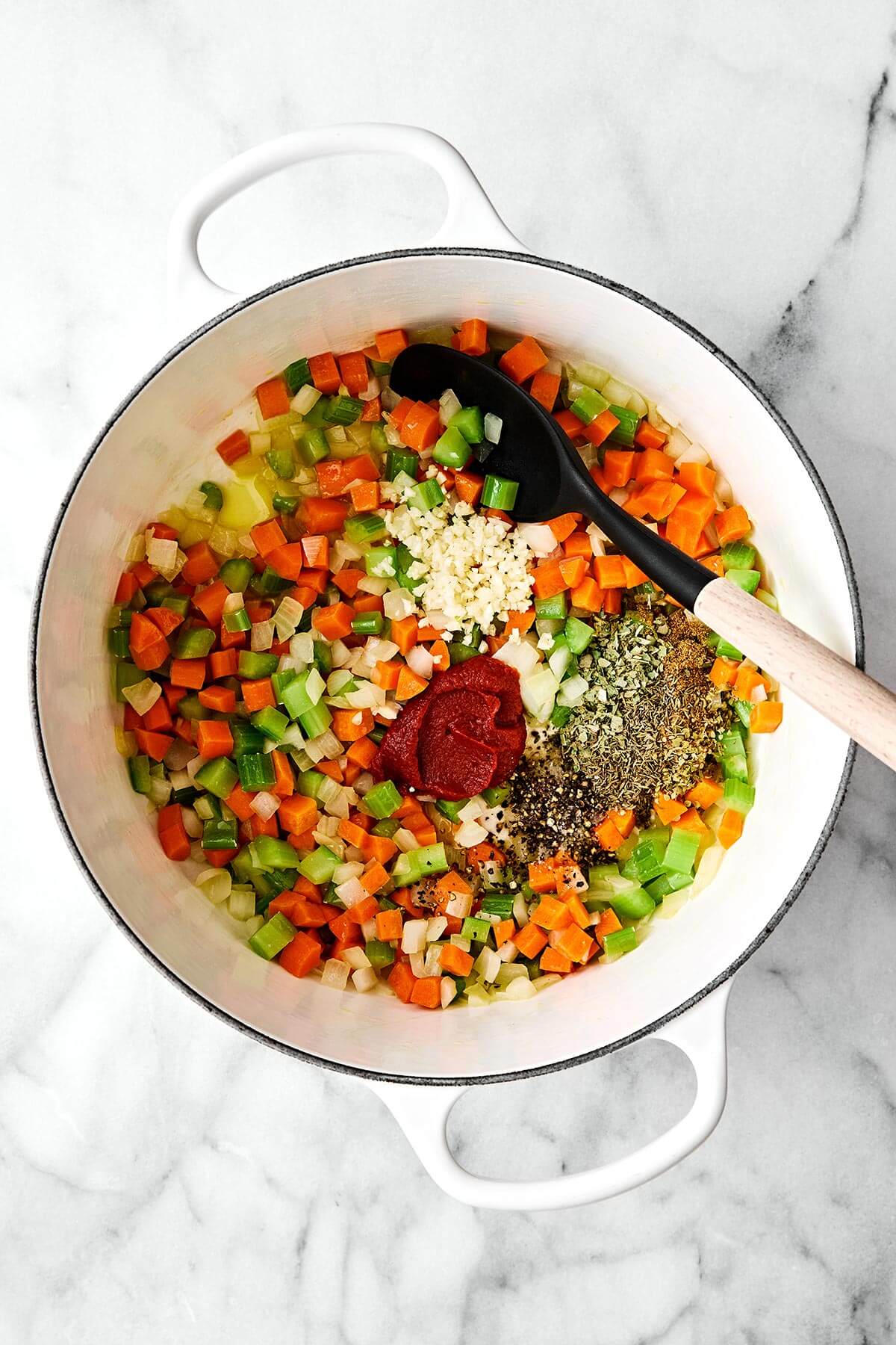 Cooking vegetables and spices in a pot.