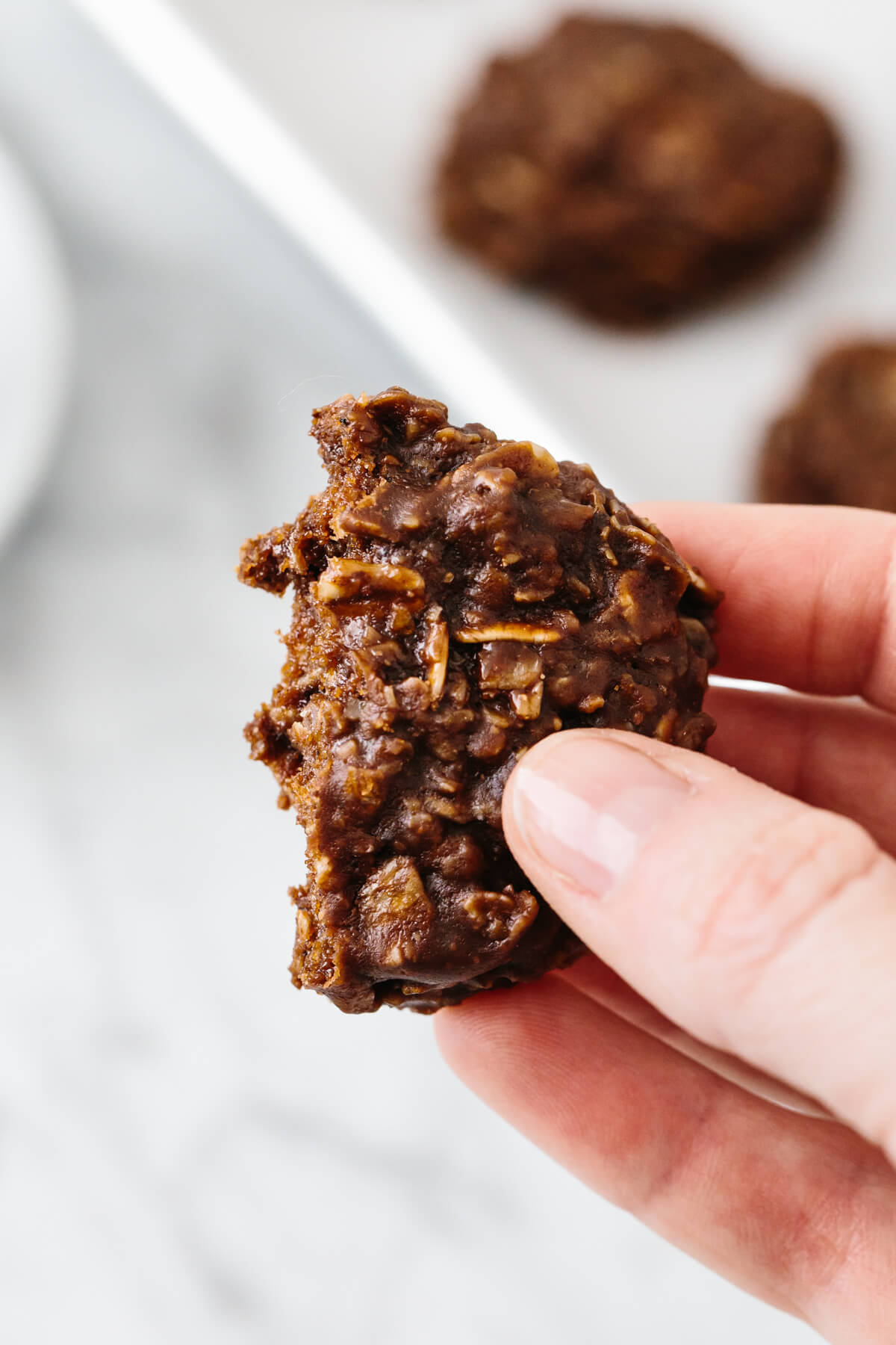 No bake cookie half eaten and held in hand.