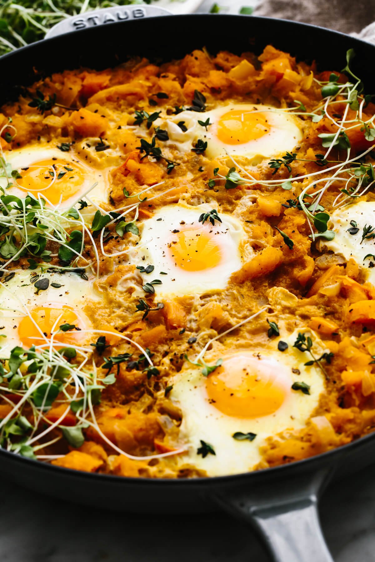 A skillet with orange shakshuka.