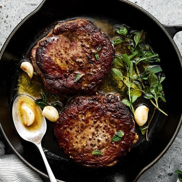 Basting butter on ribeye steak.