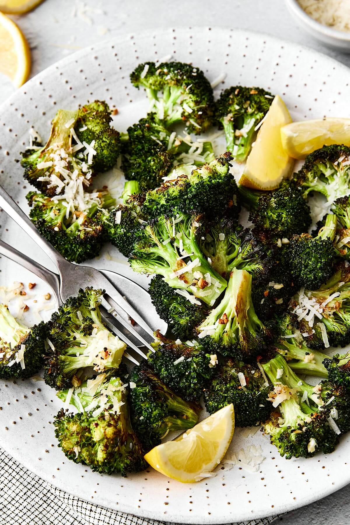 Roasted broccoli on a white plate.