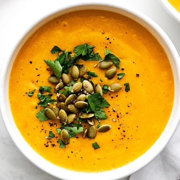 A white bowl of roasted butternut squash soup.