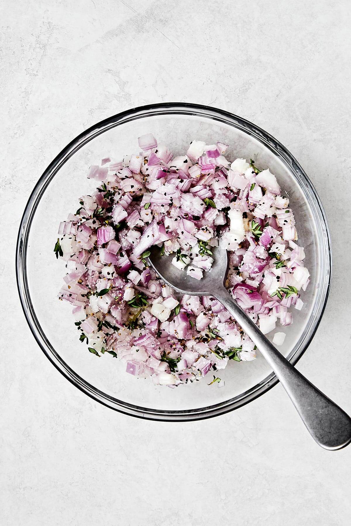 Mixing shallot mixture in a bowl.