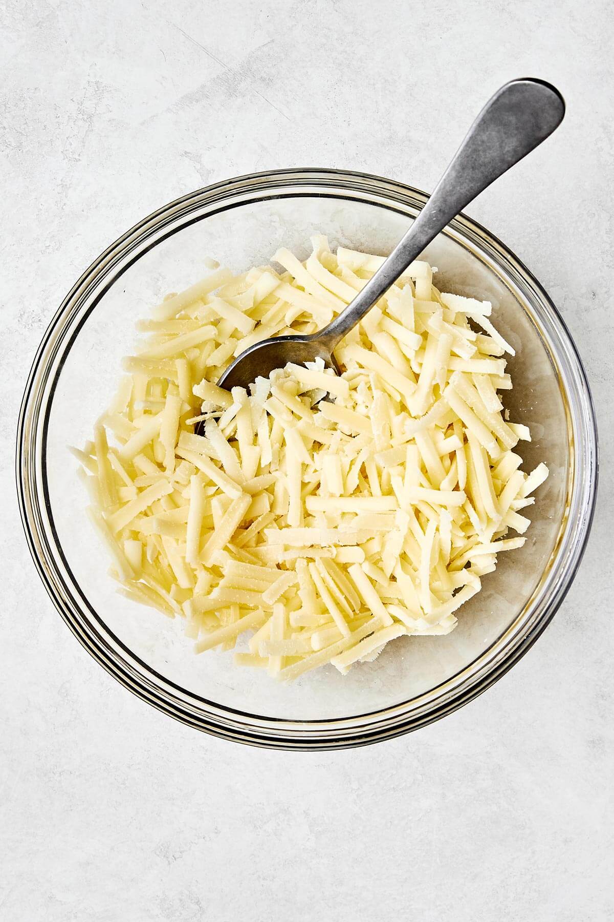 Mixing cheese blend in a bowl.