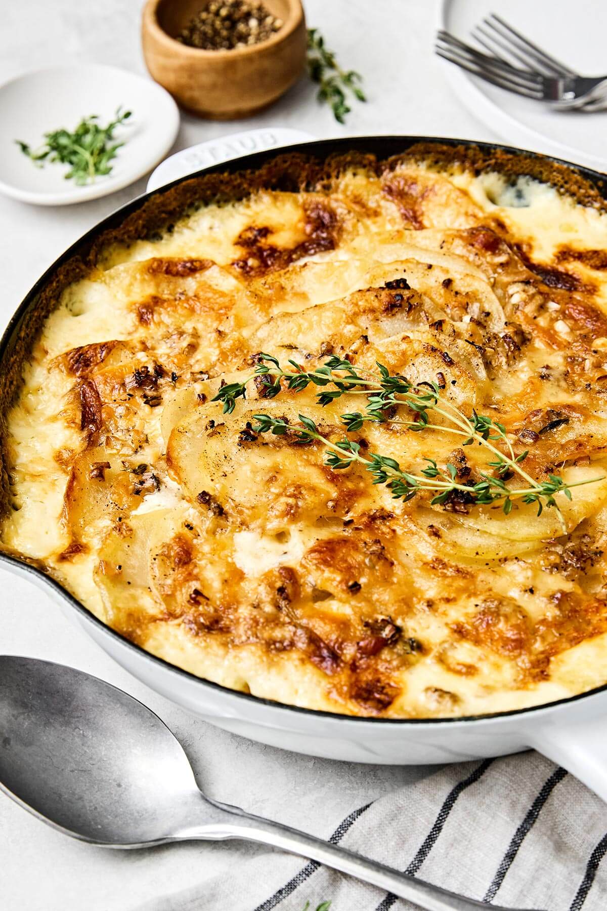 A white pan with scalloped potatoes.