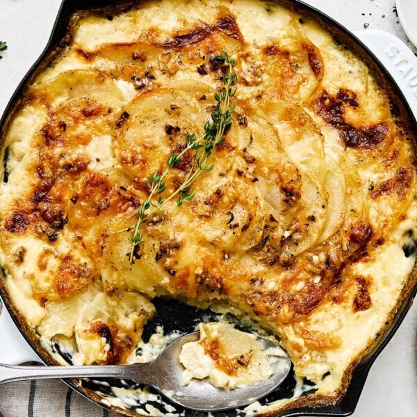 A white pan with scalloped potatoes.