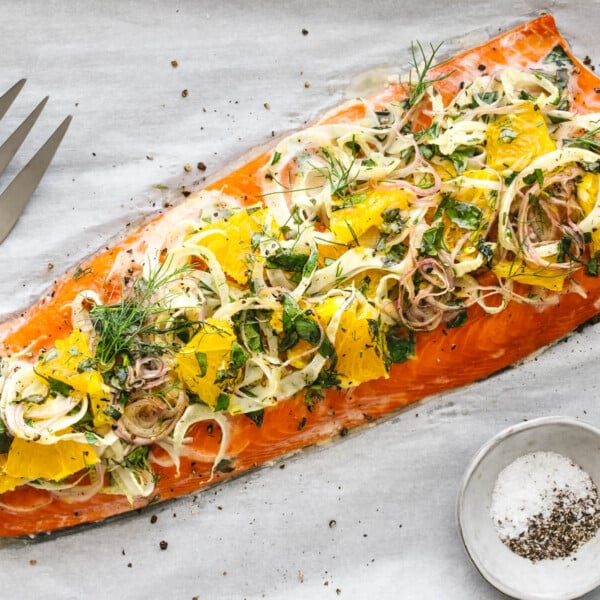 Slow roasted salmon with fennel topping next to a large fork.