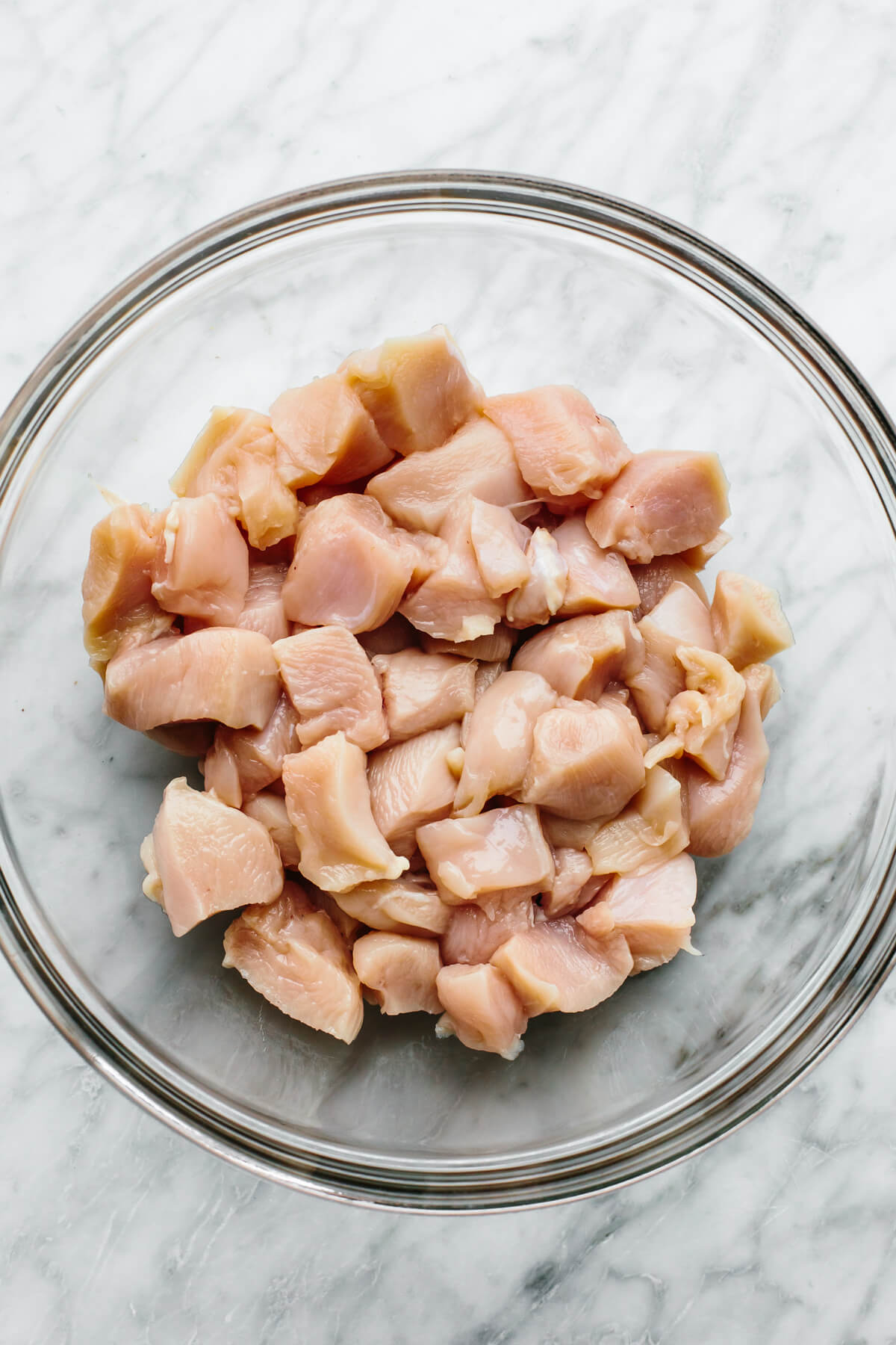 Diced chicken in a bowl for spinach artichoke chicken bake