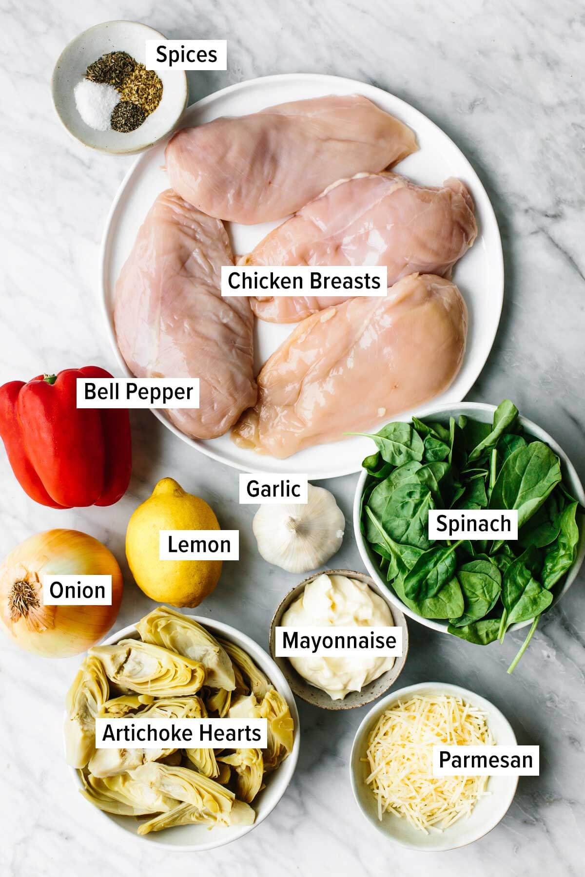 Ingredients for spinach artichoke chicken bake on a table