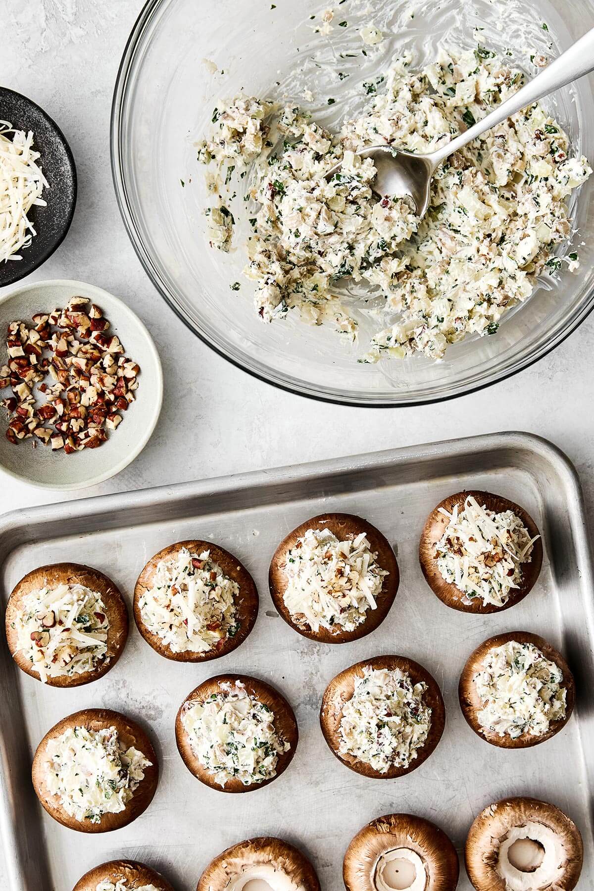 Stuffing mushrooms with cream cheese filling.