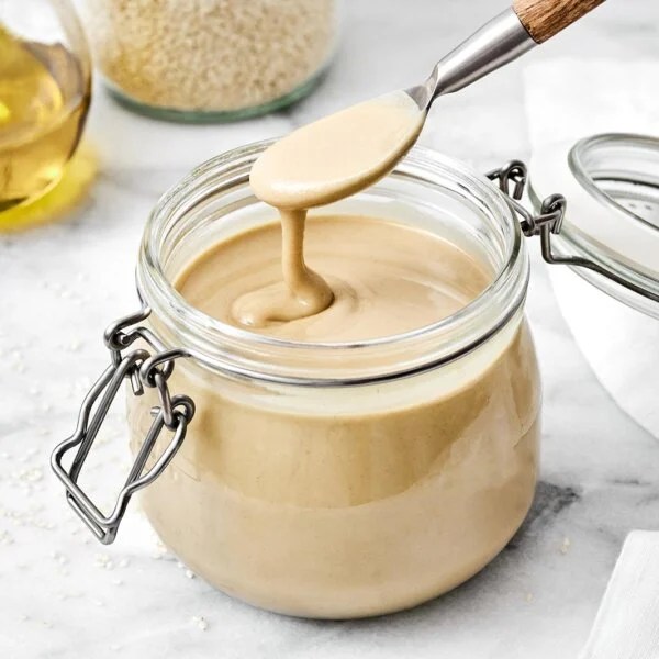 Homemade tahini in a glass jar.