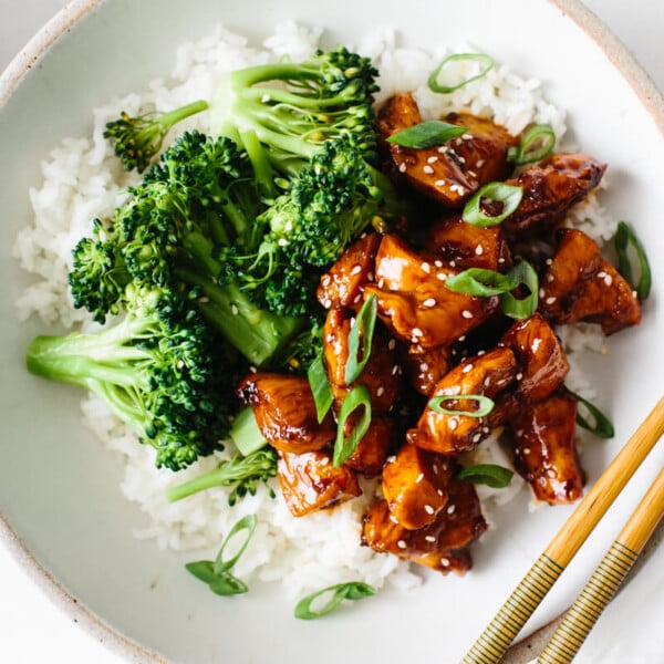 Teriyaki chicken in a bowl with rice and broccoli.